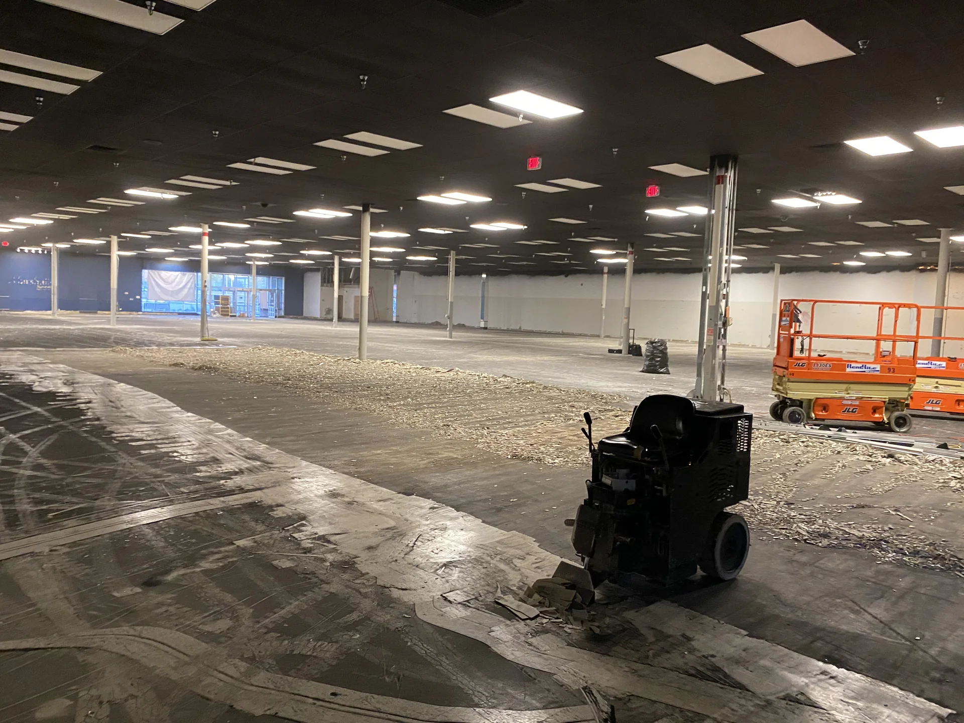 Commercial interior with exposed flooring and demolition equipment